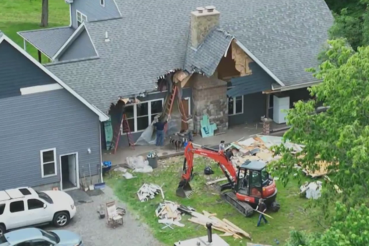 A man used an excavator to tear down the family home – while his wife and their children were still inside, police say